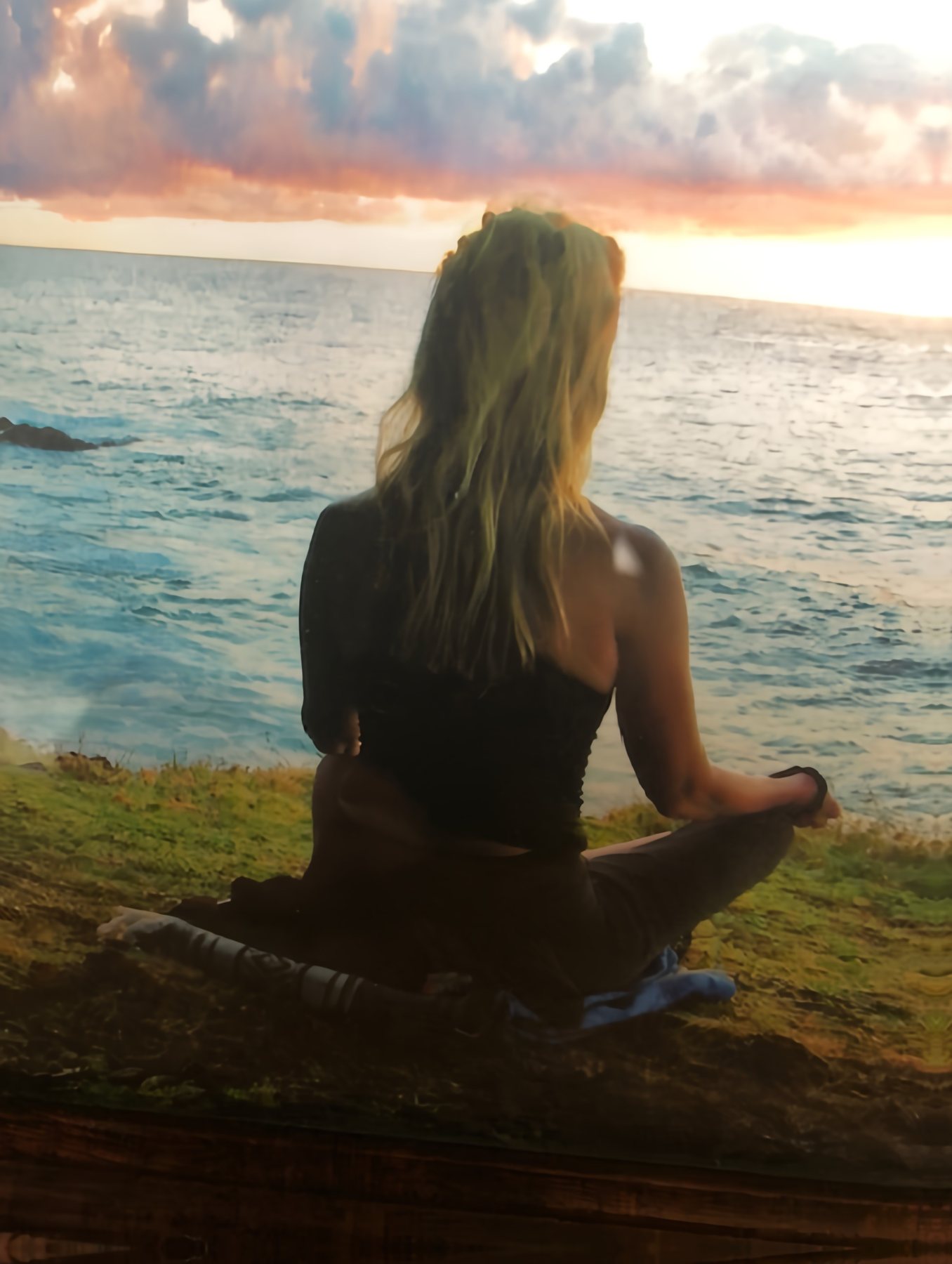 Carolyn meditating by the ocean
