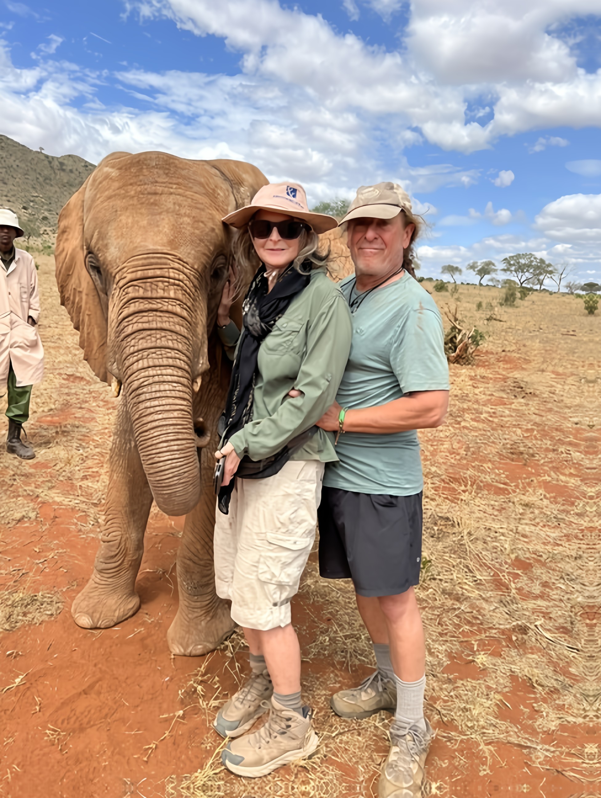 Carolyn and Bruce with an elephant at the Sheldrick Foundation in Kenya